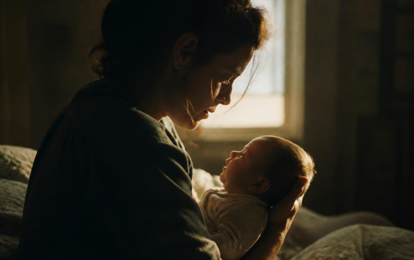 A parent holding their newborn child